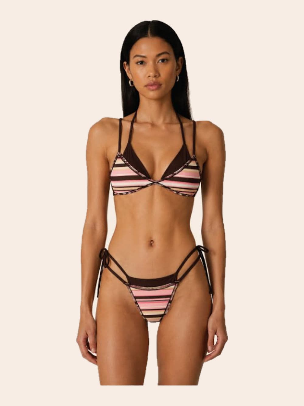 A model in a strappy triangle bikini striped in chocolate, pink and cream