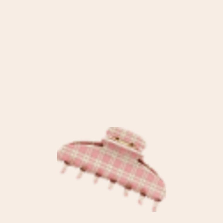 A claw hair clip in a pink and cream check